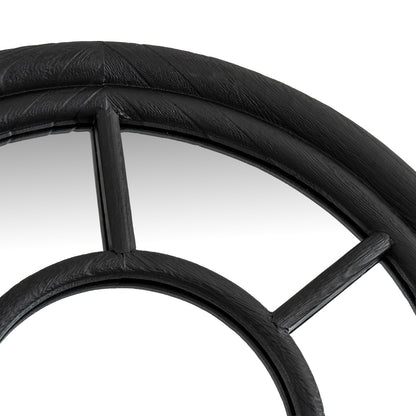 Close-up of a black metal wheel with spokes on a white background