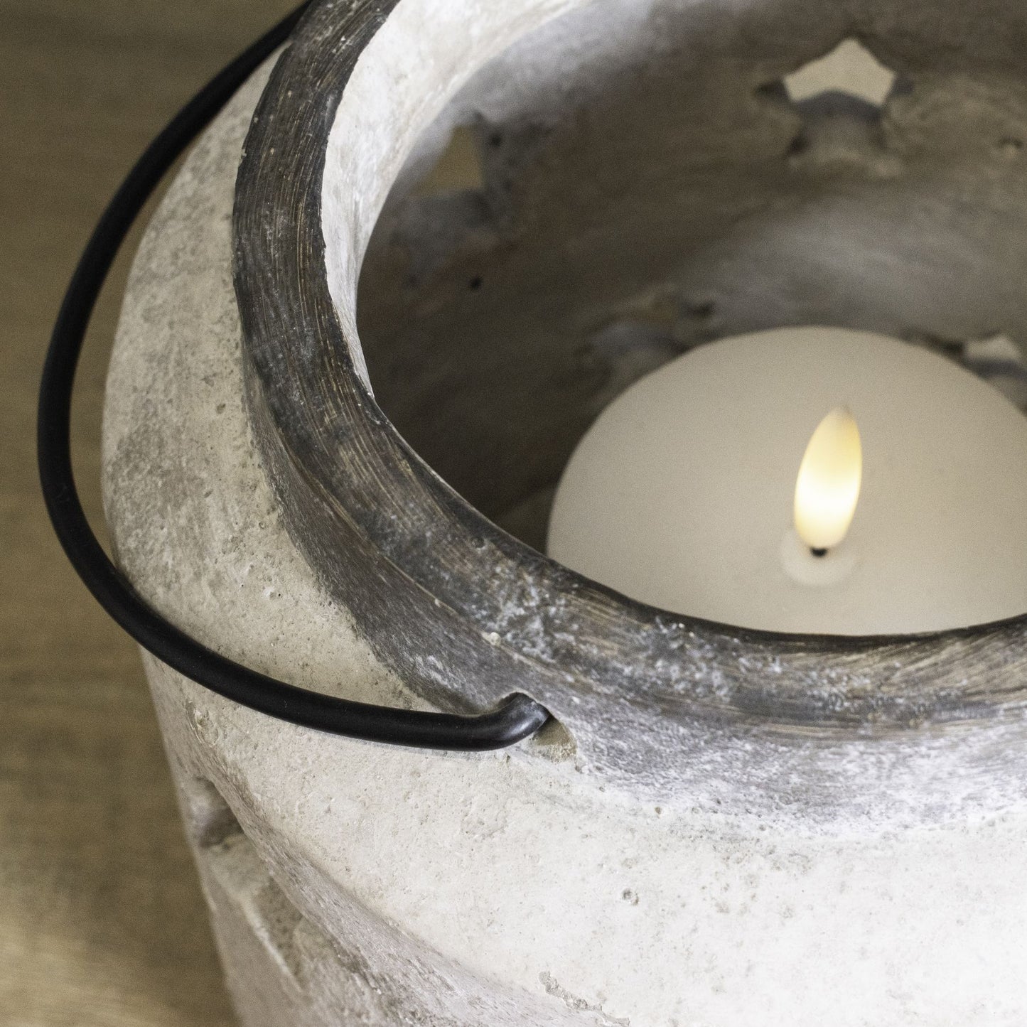 Candle in a concrete holder with a black wire