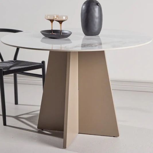 Dining table with marble top and brown base in a minimalistic setting