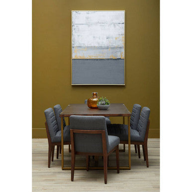 Dining room with wooden table and gray chairs against a green wall with abstract art.