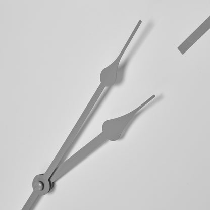 Close-up of clock hands on a light gray background