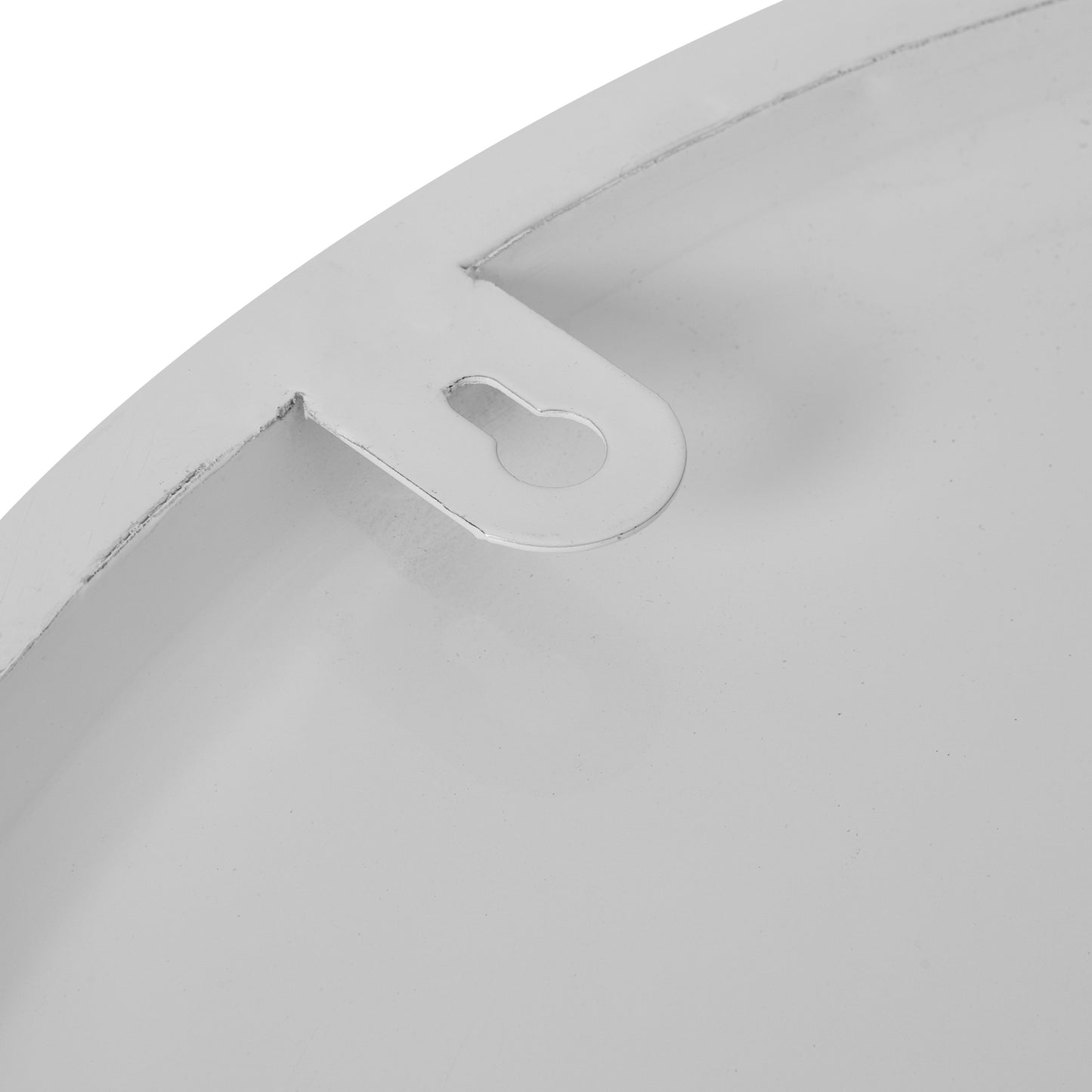Close-up of a metallic object with a cutout design on a white background