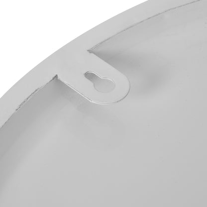 Close-up of a metallic object with a cutout design on a white background
