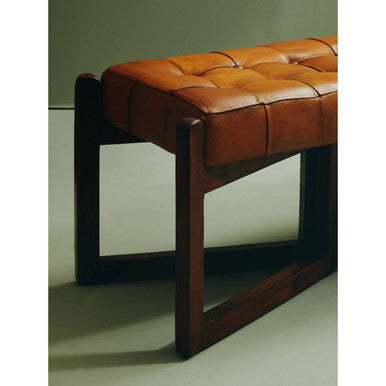 Brown leather bench with wooden frame on a plain background