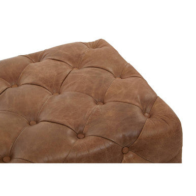 Brown leather ottoman with tufted design on a white background