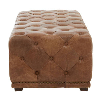 Brown tufted ottoman on a white background
