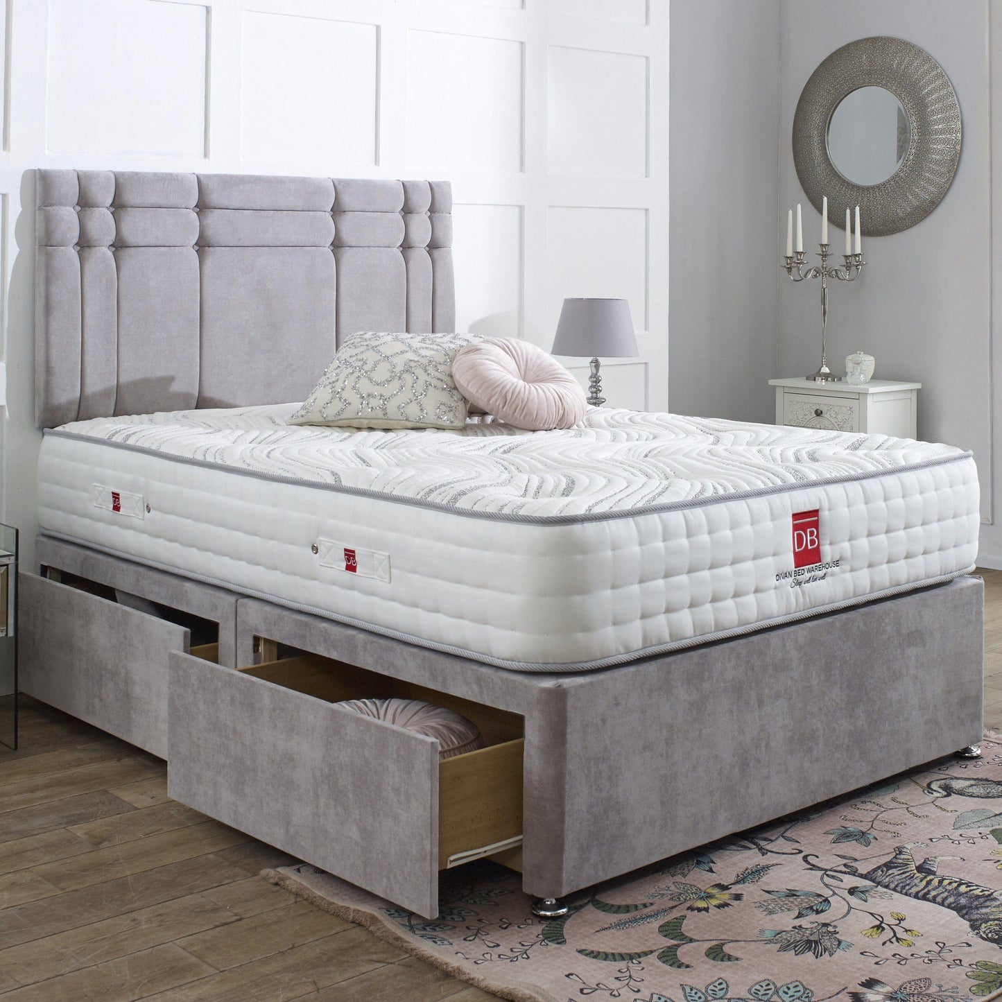 Gray upholstered bed with white mattress in a bedroom setting