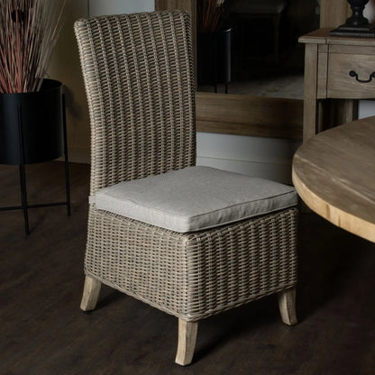 Wicker chair with a cushion in a room setting