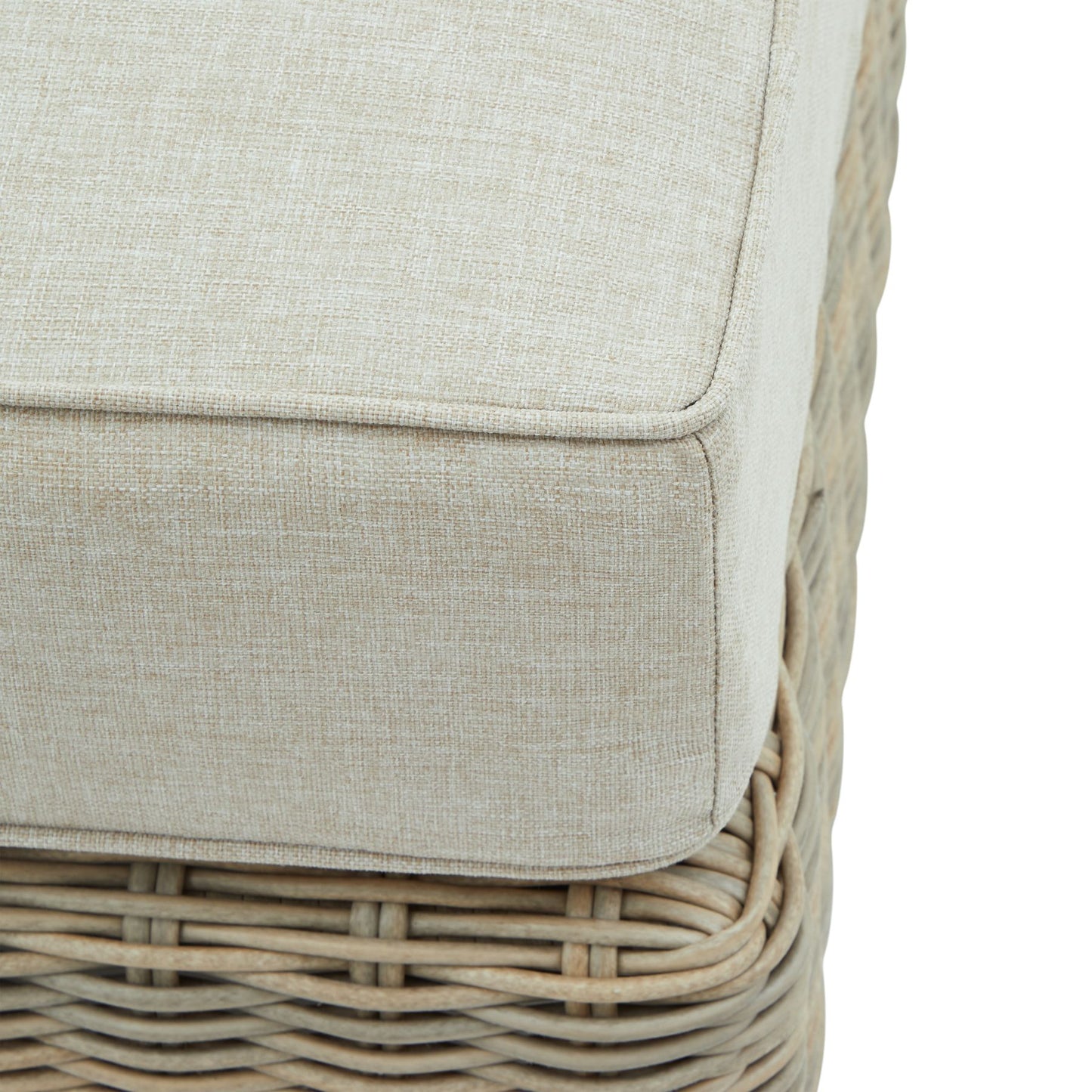 Close-up of a wicker chair with a beige cushion on a white background