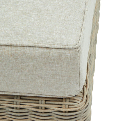 Close-up of a wicker chair with a beige cushion on a white background