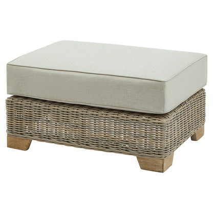 Wicker ottoman with a cushion on a white background