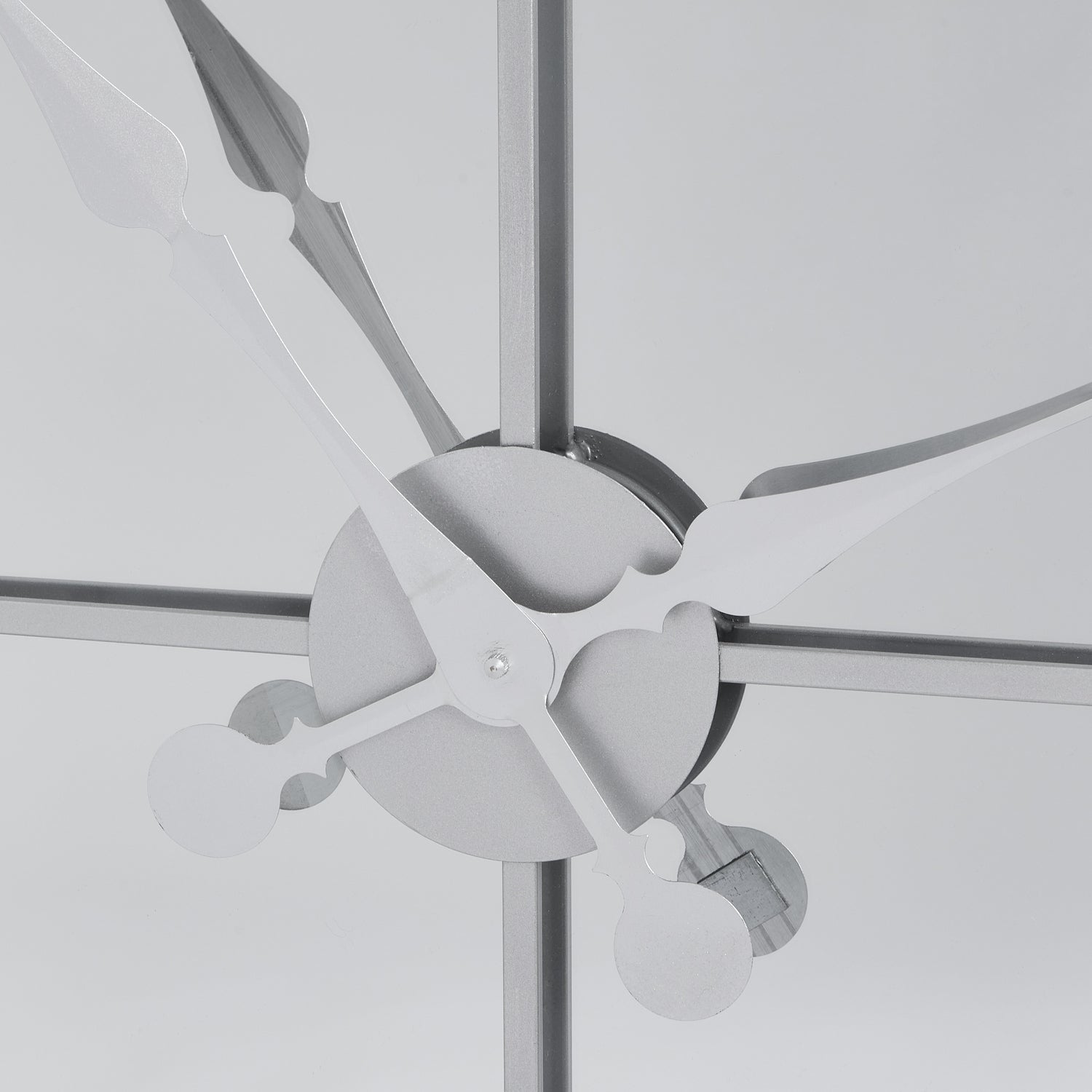 Ceiling fan with metallic blades against a light gray background