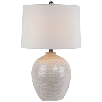Table lamp with textured white base and white shade on a white background
