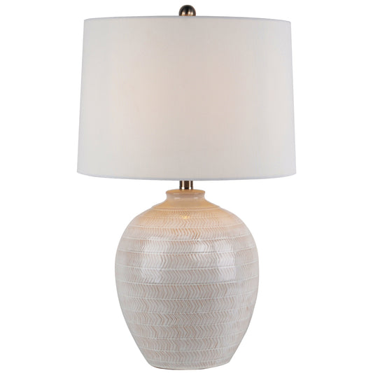Table lamp with textured white base and white shade on a white background