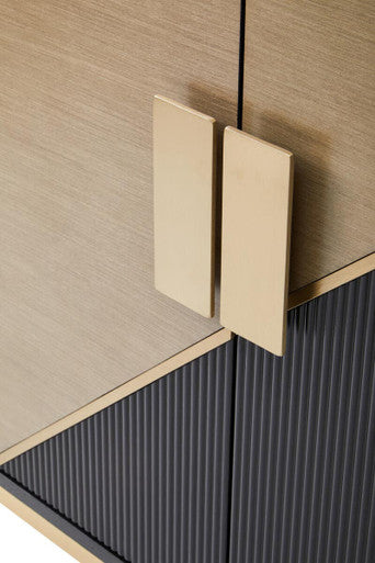 Close-up of a modern cabinet with gold handles and a striped pattern.