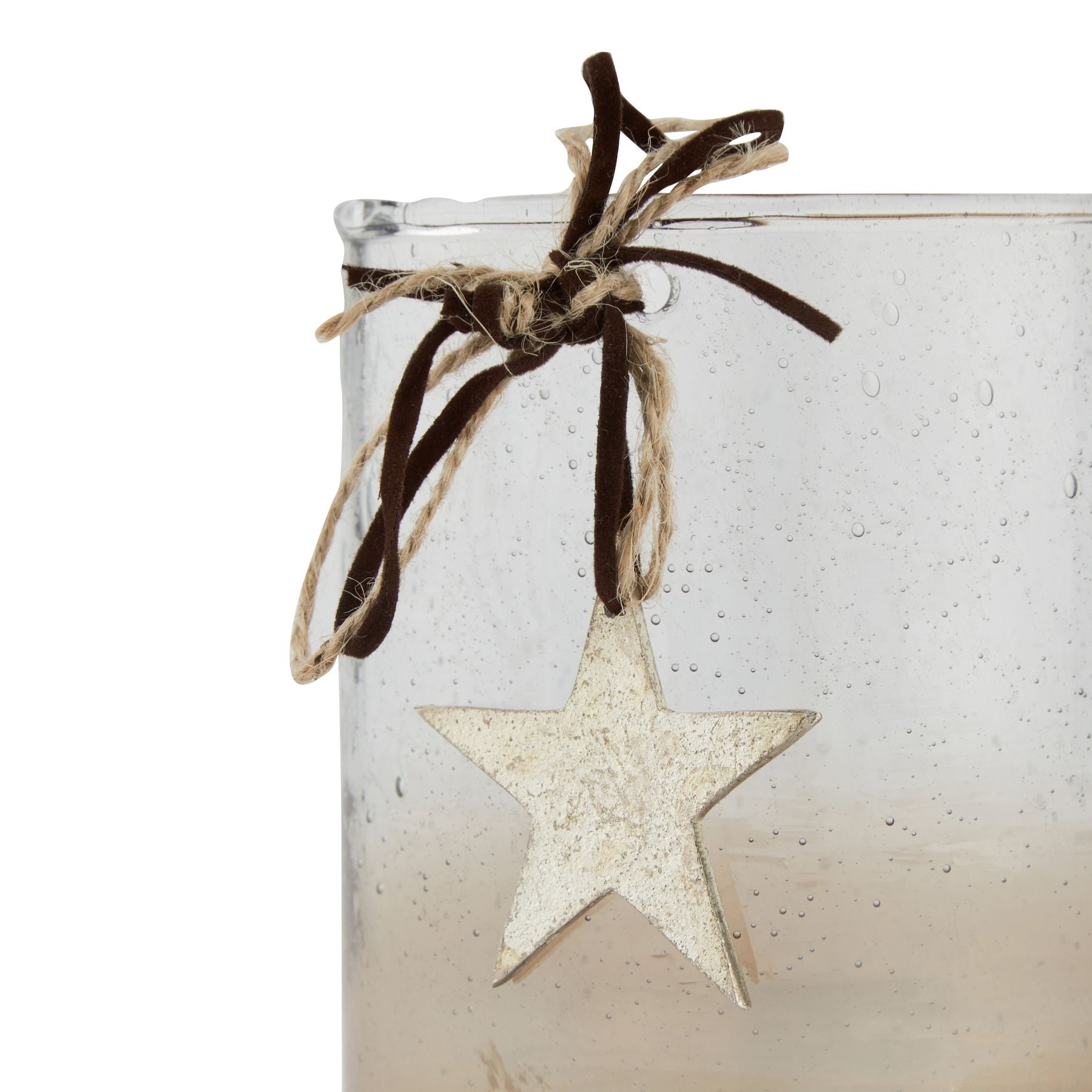 Decorative candle with a star ornament and twine on a white background