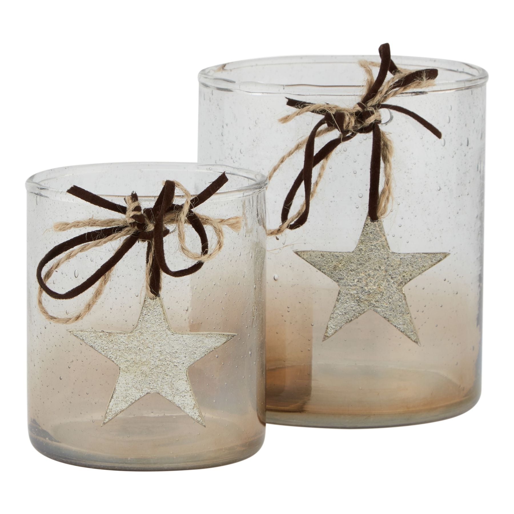 Two glass candle holders with star designs and twine bows on a white background