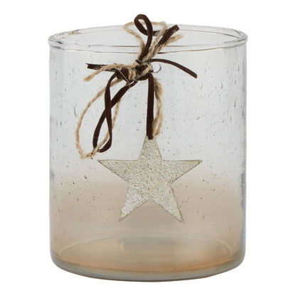 Clear glass candle holder with star decoration and string on a white background