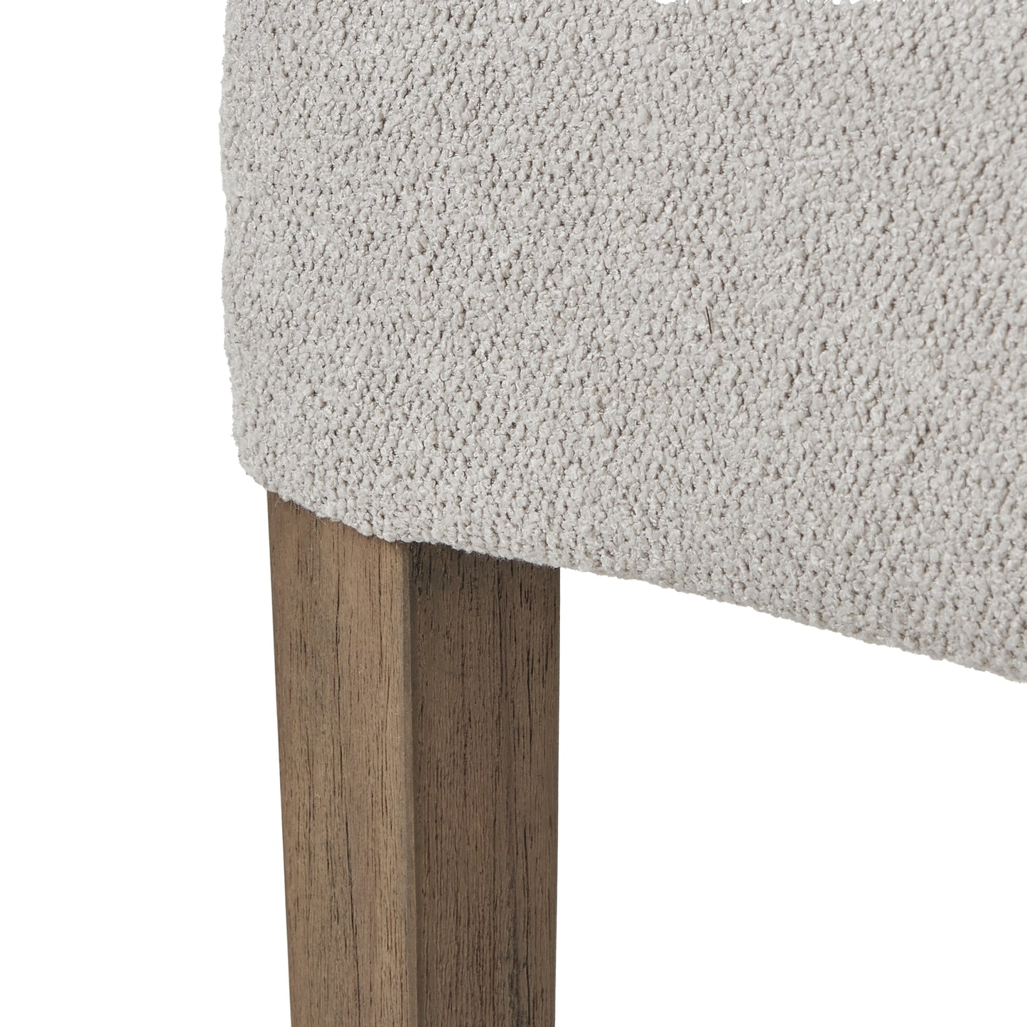 Close-up of a textured gray cushioned chair with wooden legs on a white background