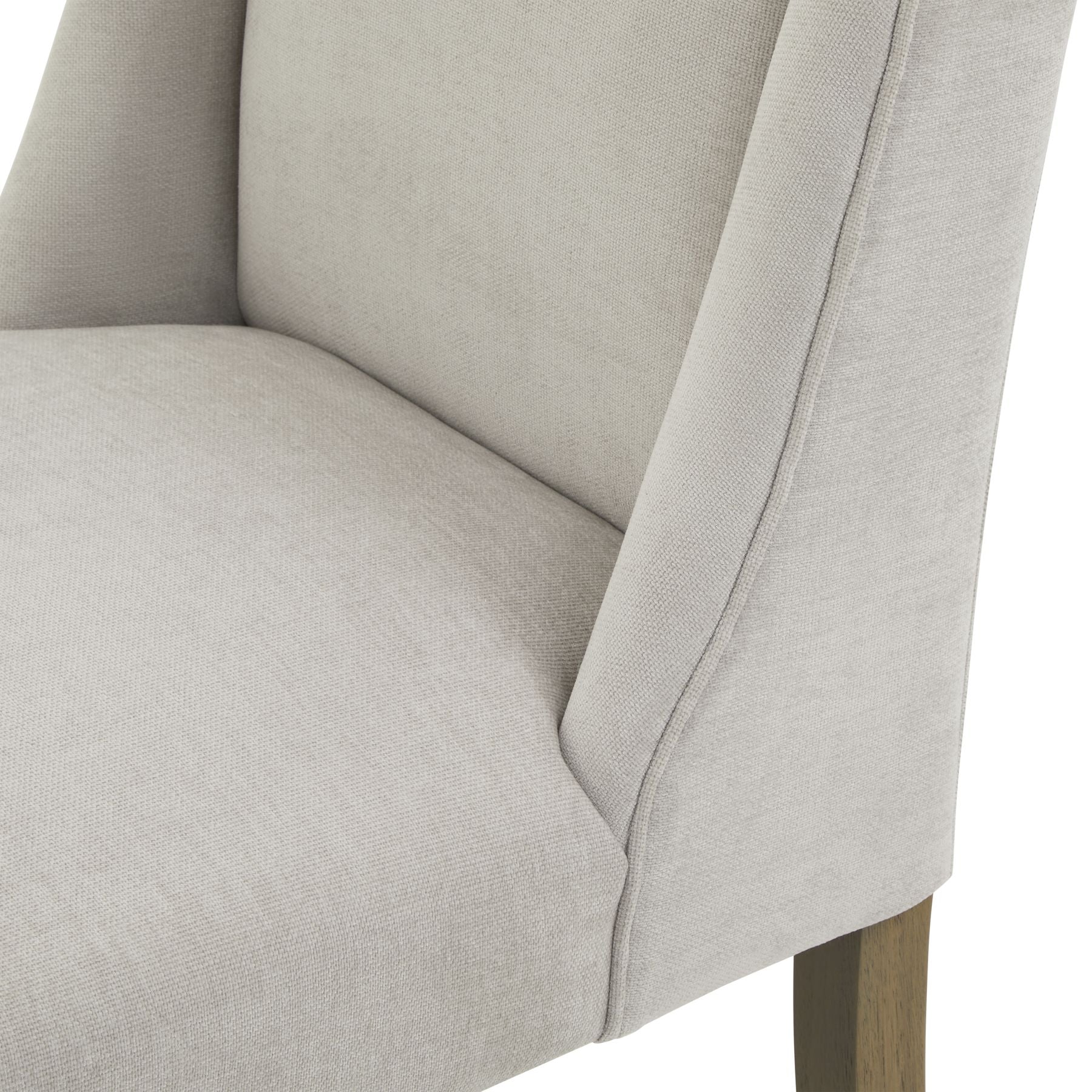 Close-up of a light gray upholstered chair with wooden legs on a white background