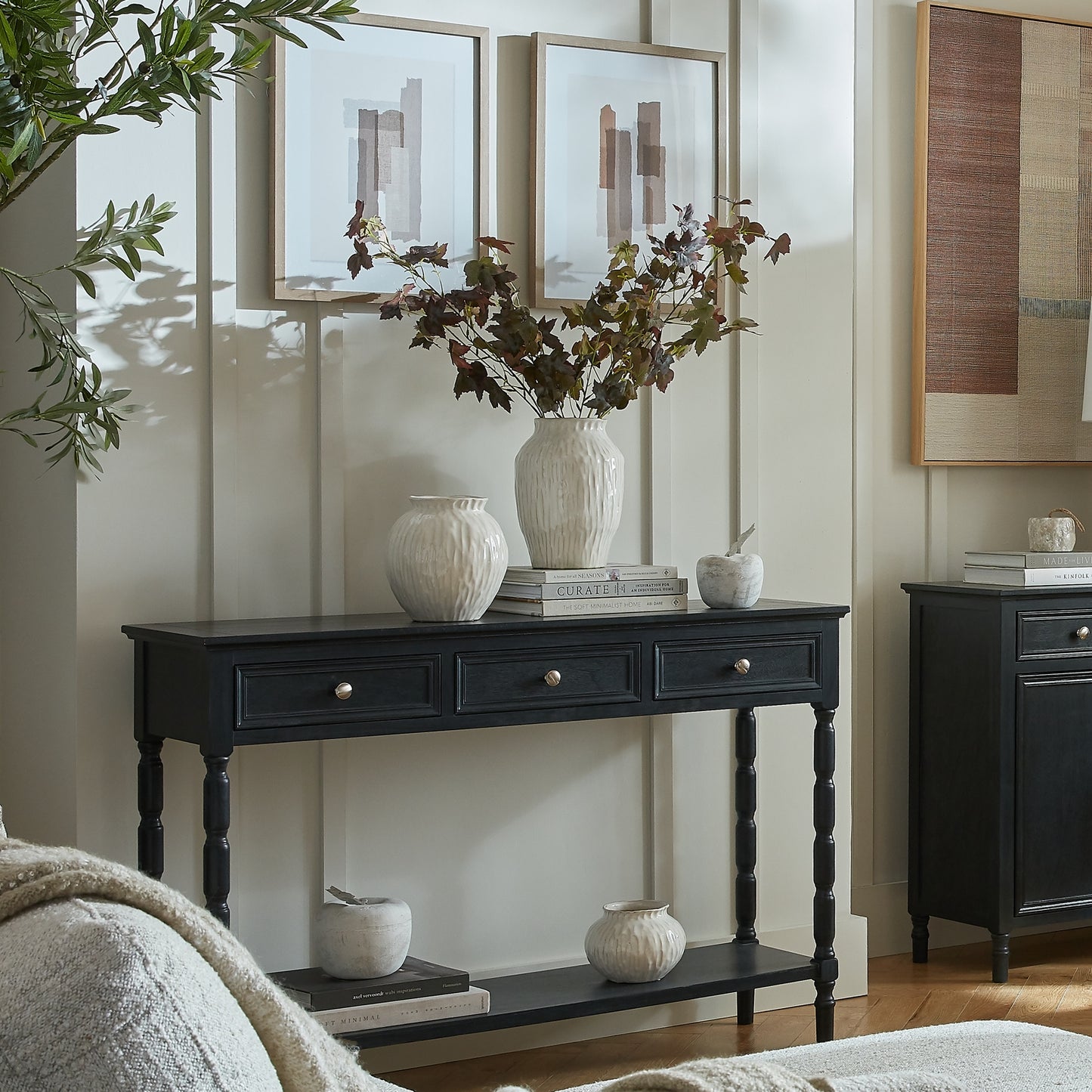 Black console table with decorative items in a room setting