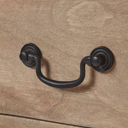 Black metal handle on a wooden surface