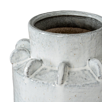 Close-up of a textured ceramic vase with a white and gray speckled design.
