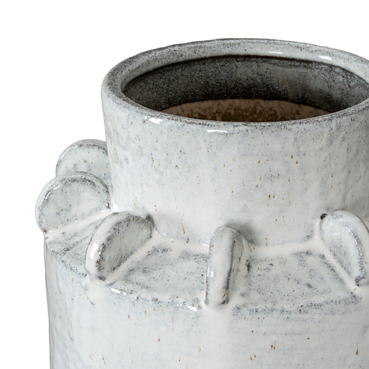Close-up of a textured ceramic vase with a white and gray speckled design.