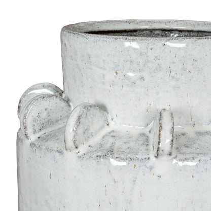 Close-up of a textured ceramic vase with decorative elements on a white background