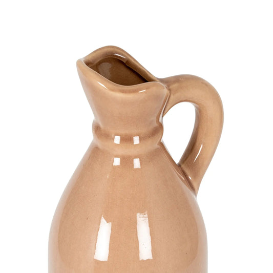 Beige ceramic pitcher on a white background