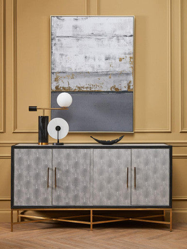 Decorative sideboard with abstract art on a beige wall