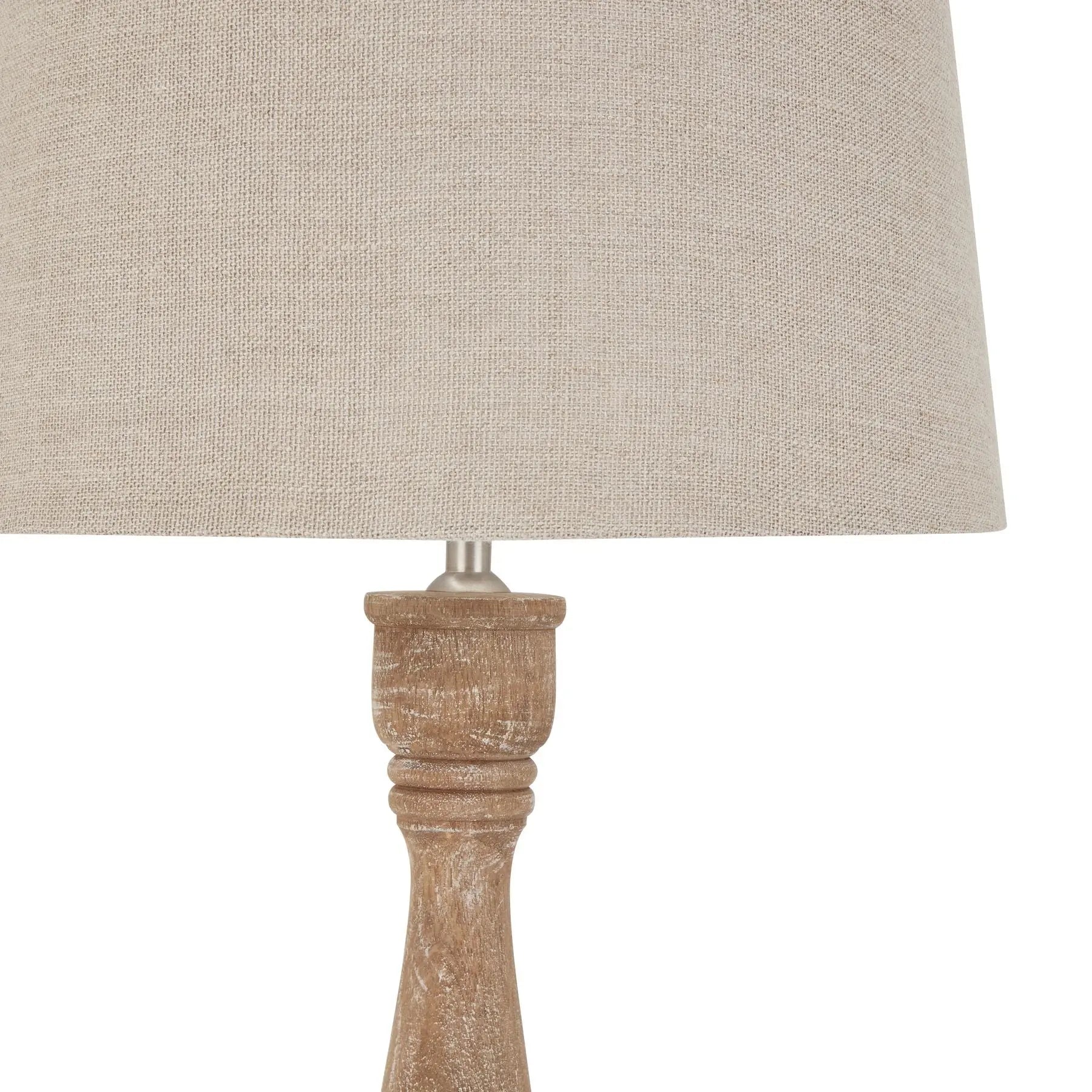Lamp with a beige fabric shade and wooden base on a white background