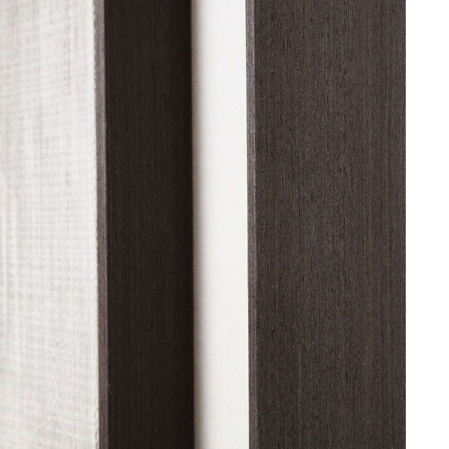 Close-up of fabric swatches in white, dark brown, and gray.