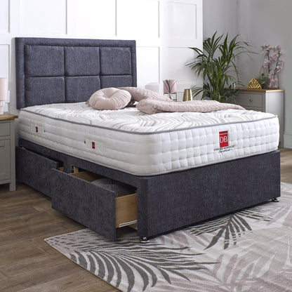 Gray upholstered bed with white mattress and drawers in a bedroom setting.