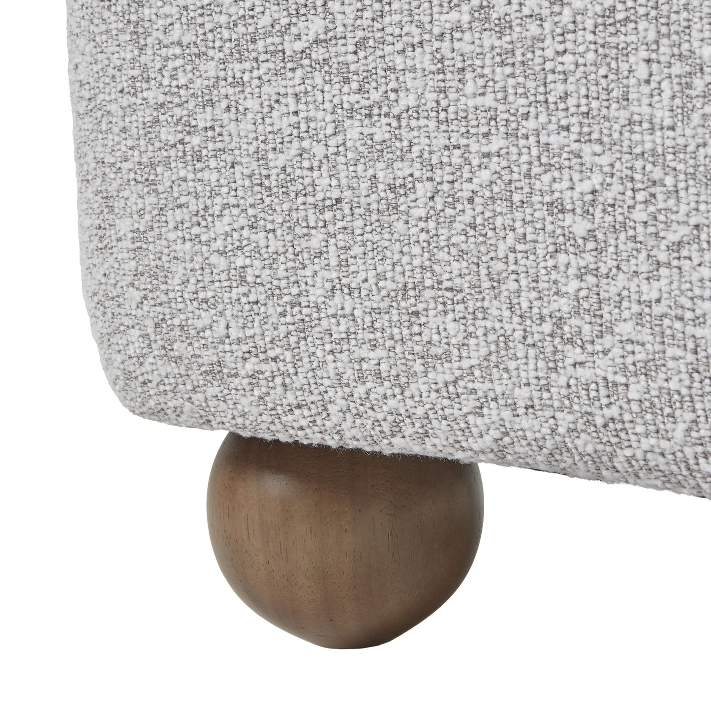Close-up of a textured gray fabric surface with a wooden leg.