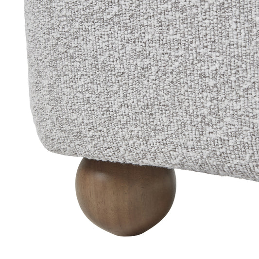 Close-up of a textured gray fabric surface with a wooden leg.