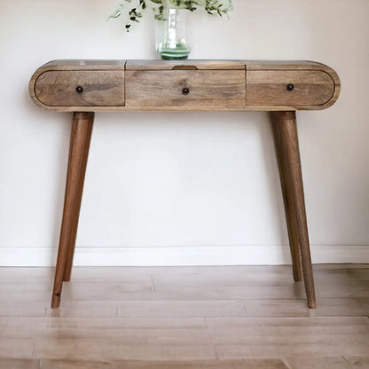 Wooden console table with drawers against a white wall