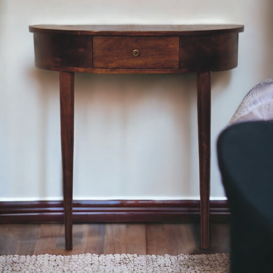 Wooden console table with a single drawer against a white wall.