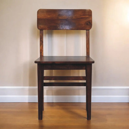 Wooden chair against a plain wall
