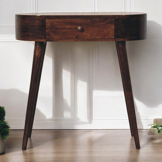 Wooden side table with a single drawer on a wooden floor.