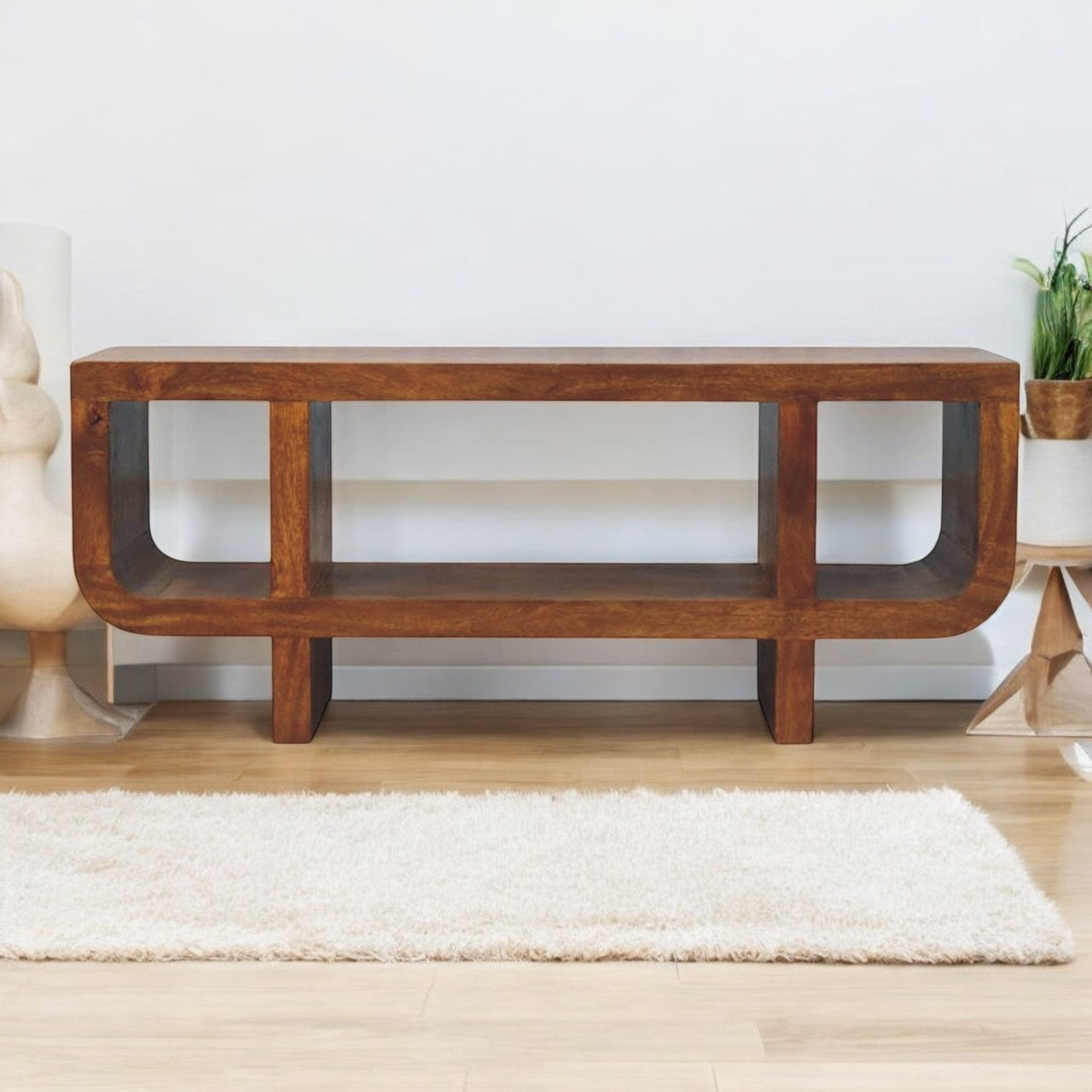 Wooden console table in a room with a white wall and light-colored floor.