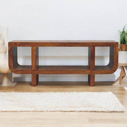 Wooden console table in a room with a white wall and light-colored floor.