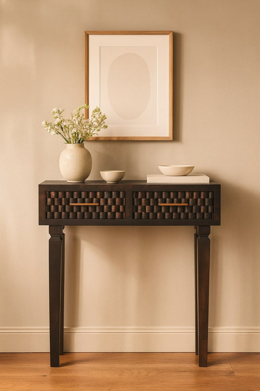 Console table with decorative items against a beige wall