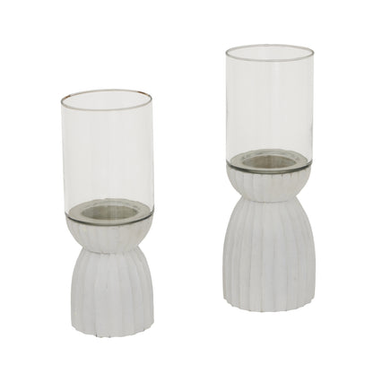 Two glass candle holders with ribbed metal bases on a white background