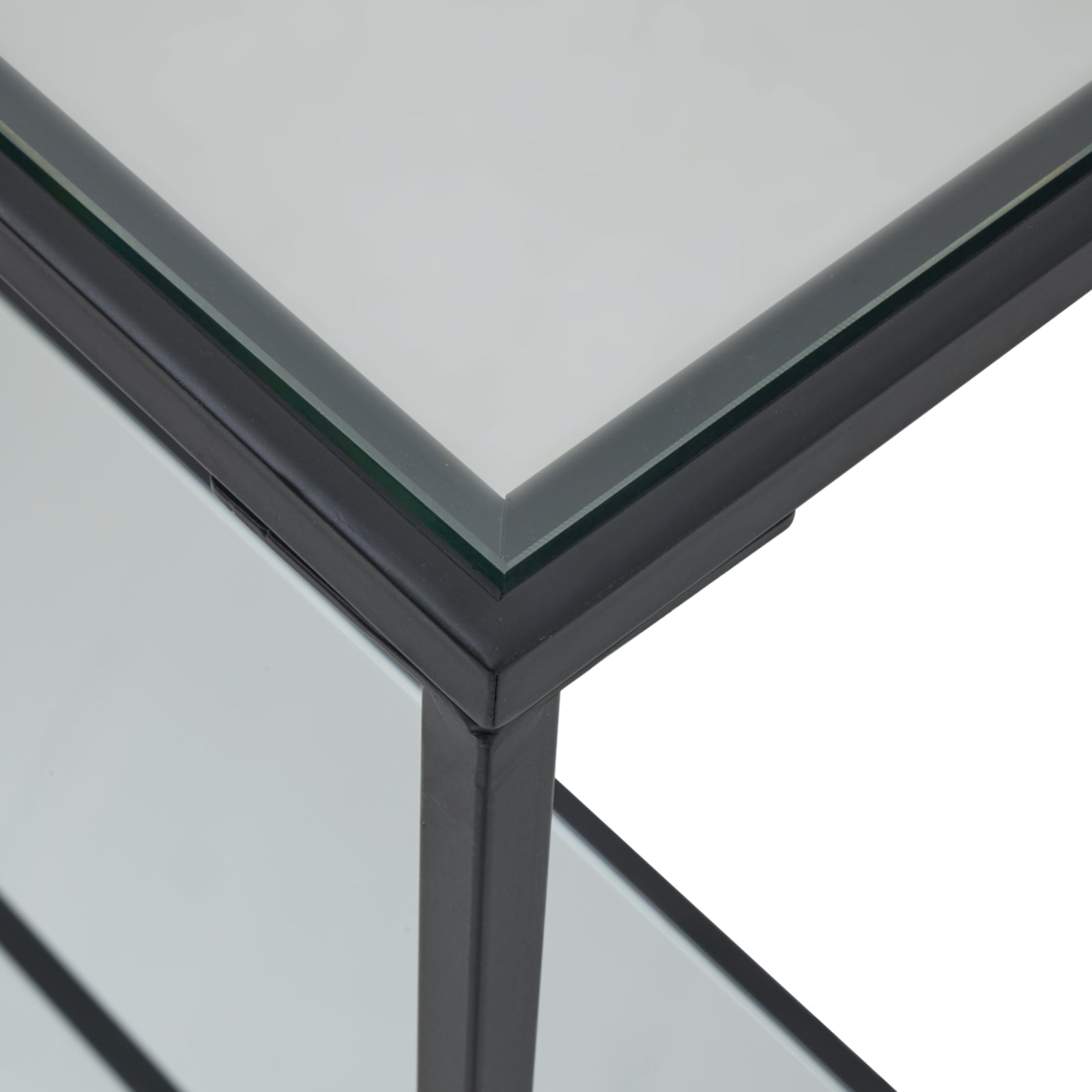 Close-up of a glass table with a metal frame on a white background
