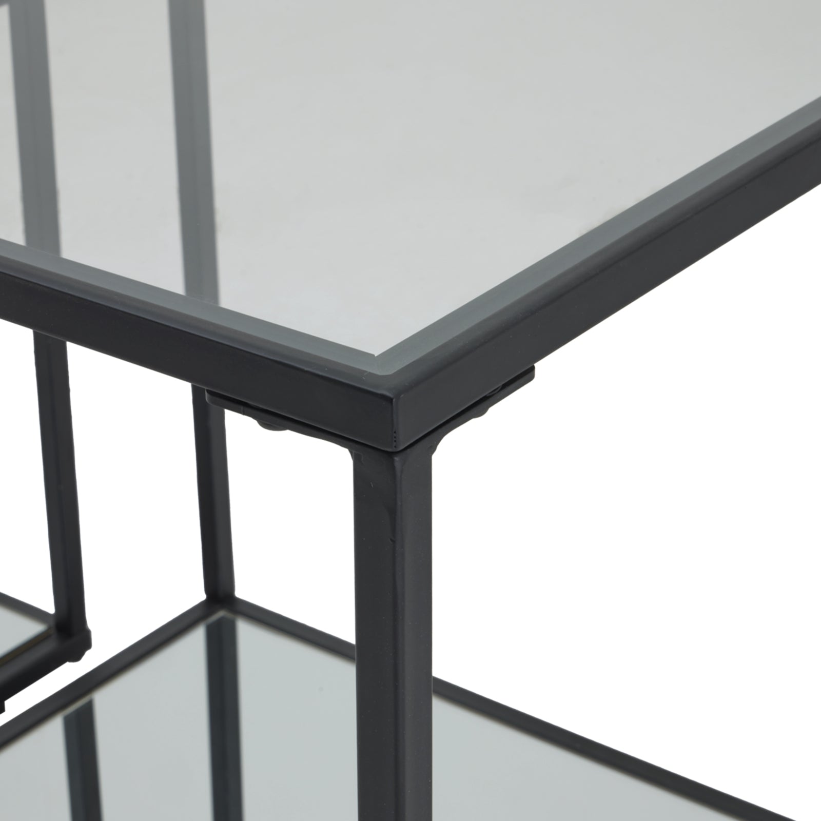 Glass table with black metal frame on a white background