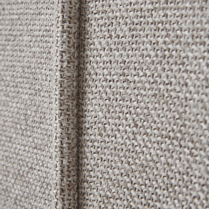 Close-up of textured beige fabric with a visible seam.