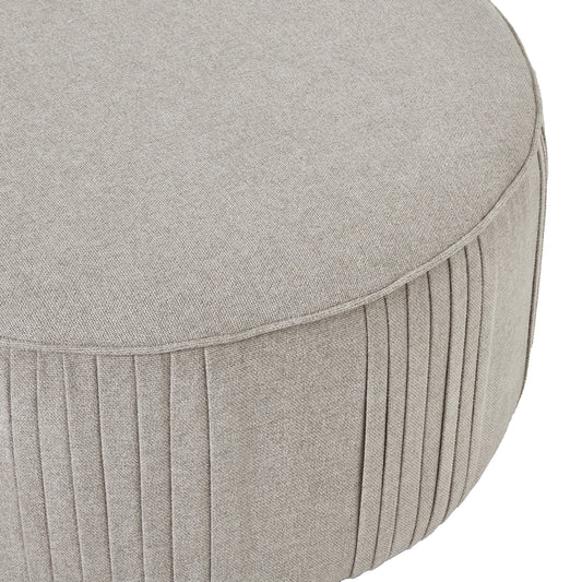 Round gray ottoman with pleated design on a white background