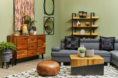Living room with wooden furniture, gray sofa, and decorative items.