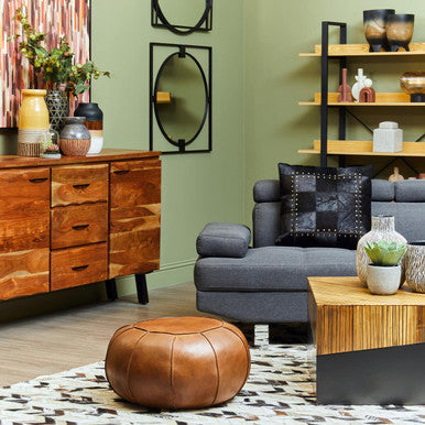 Living room with wooden furniture, gray sofa, and decorative items.